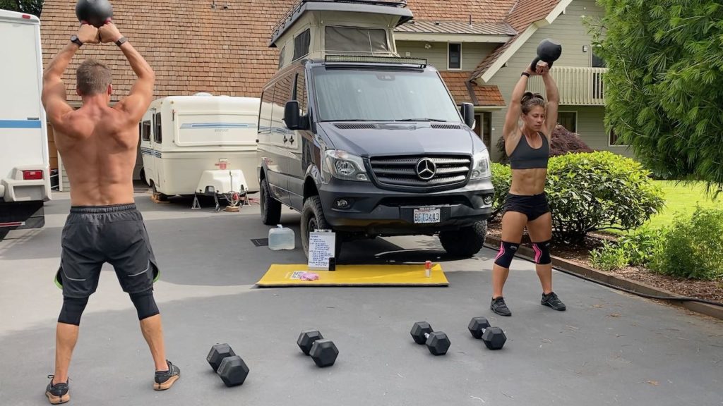 Emily and Joe doing kettlebell swings in the driveway