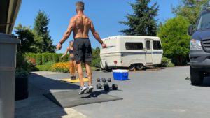 Emily and Joe doing double unders (jump rope) in the driveway for an at-home gym workout