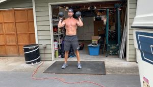 Joe doing dumbbell cleans outside of garage